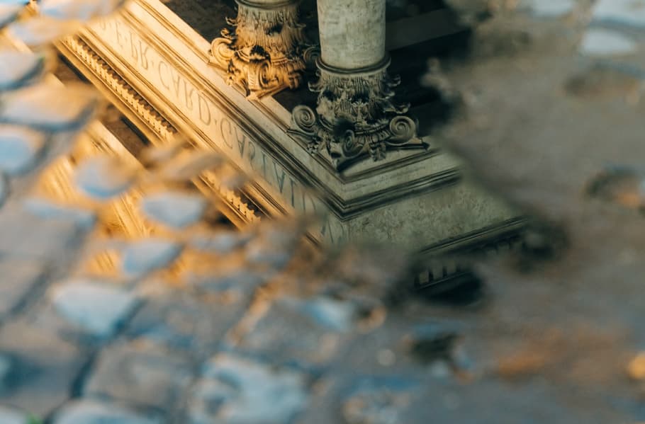 Historic architecture reflected in a puddle