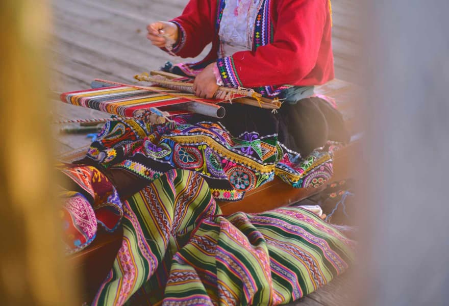 Artisan weaving colourful textiles